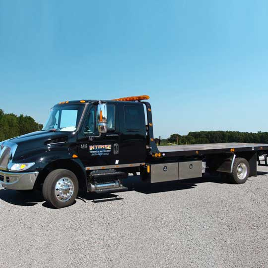 Flatbed tow truck in Intense Towing lot in Clinton Maryland